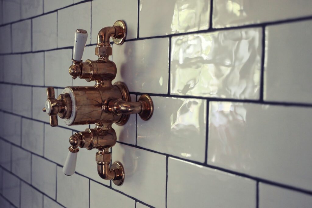 brass door knob on white ceramic tile