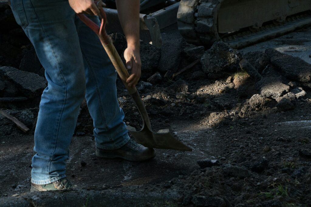 person holding brown wooden shovel